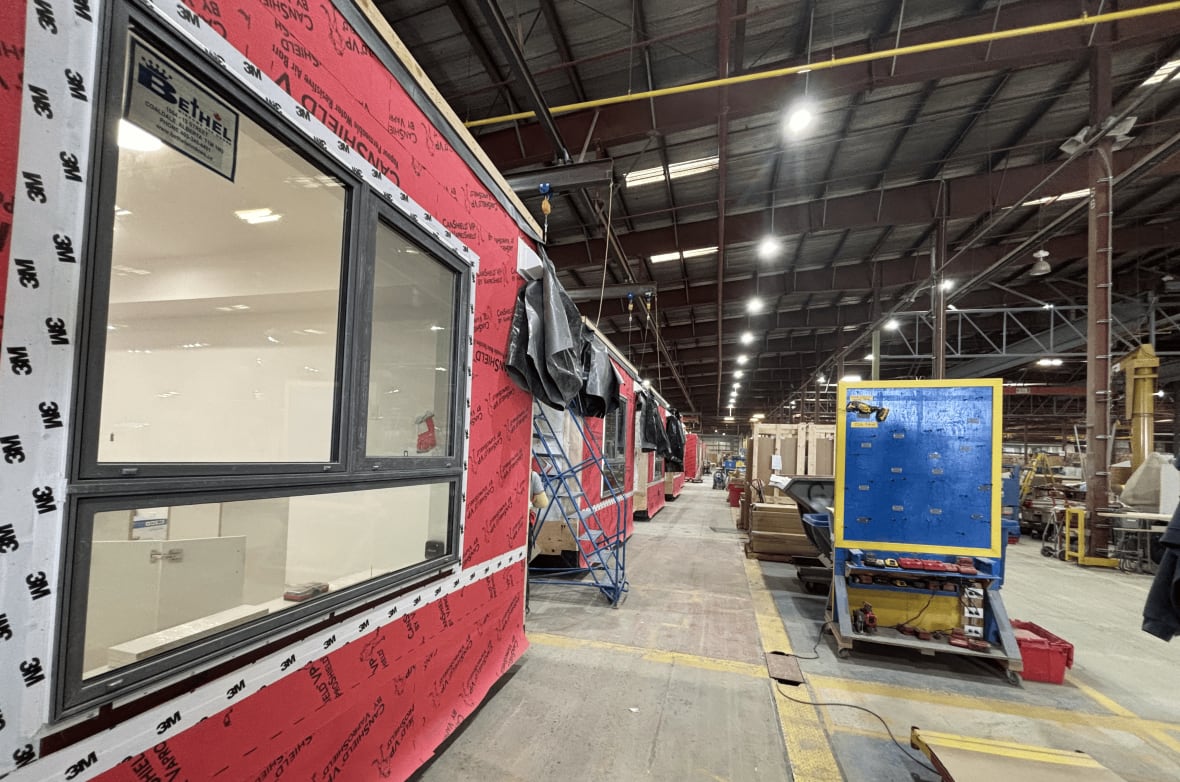 A lineup of modular units being built at a factory.