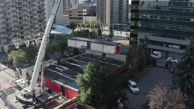 Piece by piece, cranes lift 84 prefabricated rentals into place in downtown Calgary