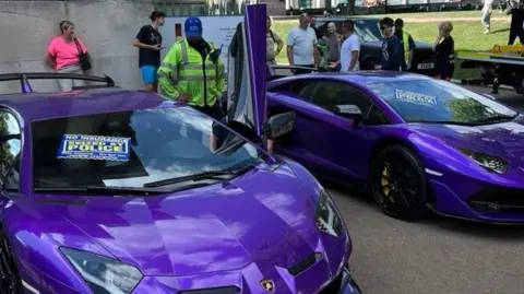 Motor Insurers' Bureau Two purple Lamborghinis, each with a sign that reads: "Seized by Police" on the windscreen