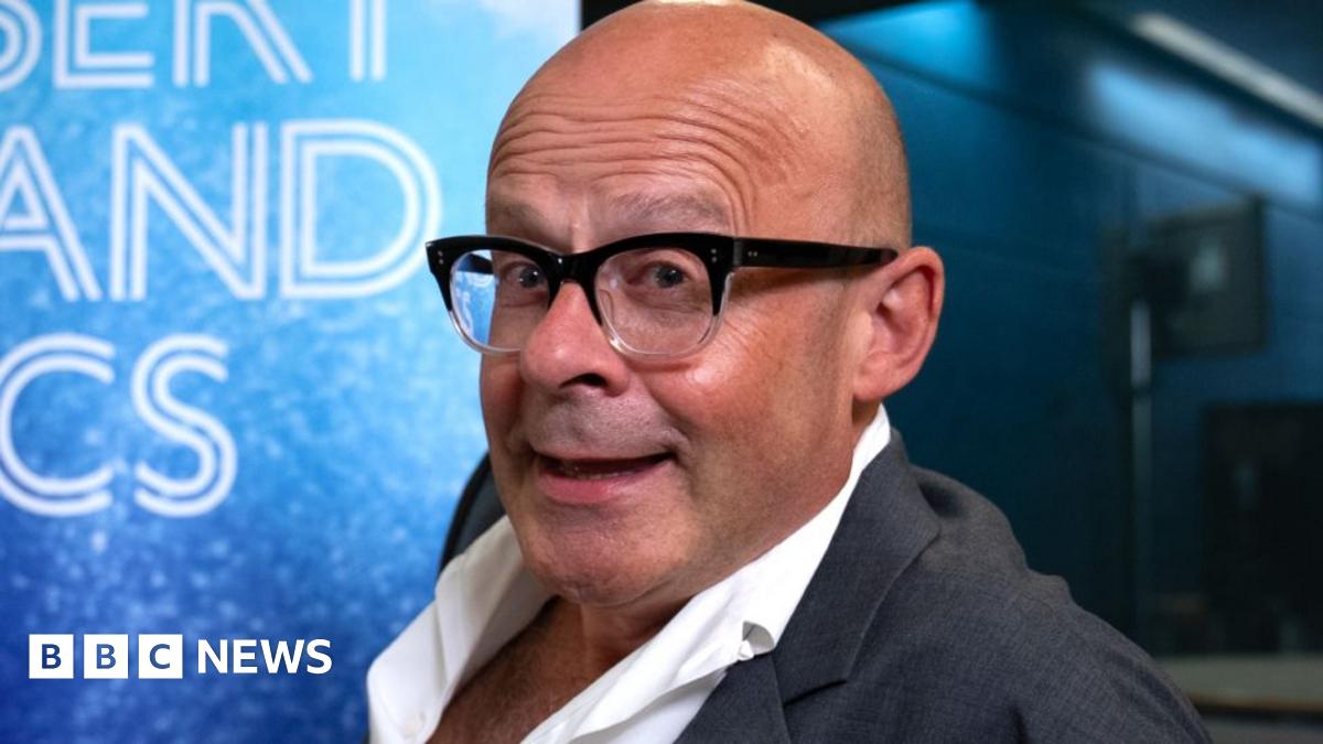 Harry Hill in the Desert Island Discs studio, wearing a suit with an open-collar shirt