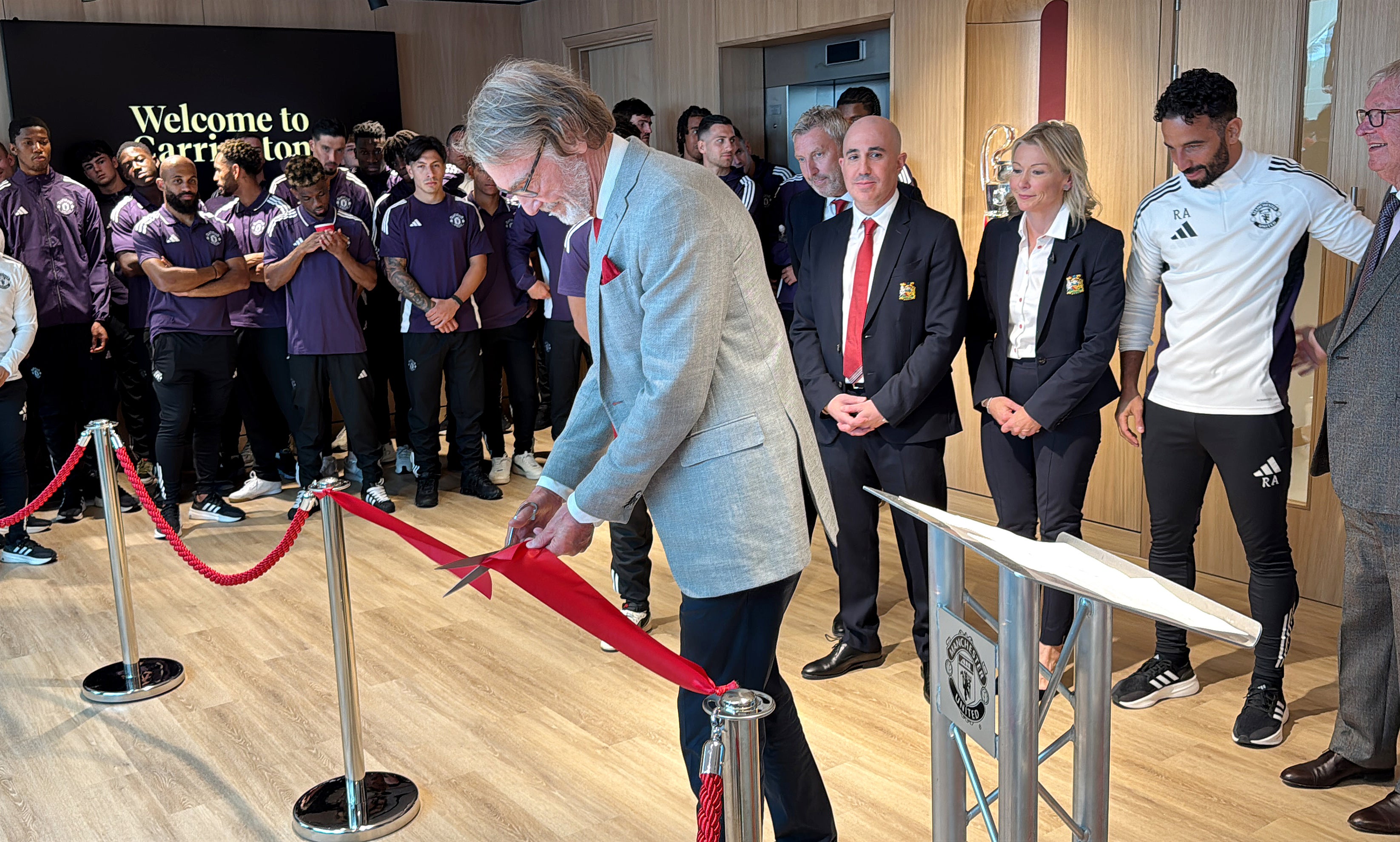 Sir Jim Ratcliffe cuts the ribbon during the reopening ceremony at Carrington