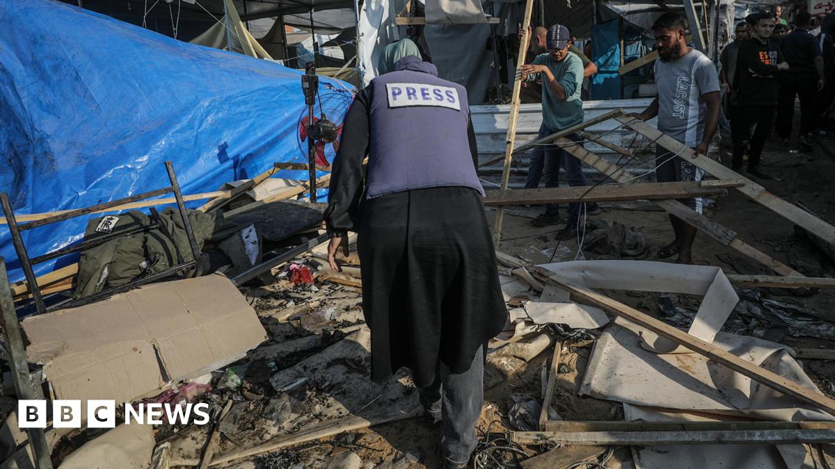 A Palestinian journalist inspects damaged shelters following an Israeli airstrike inside the Al Aqsa Martyrs Hospital compound in Deir Al Balah, central Gaza Strip, 9 November 2024