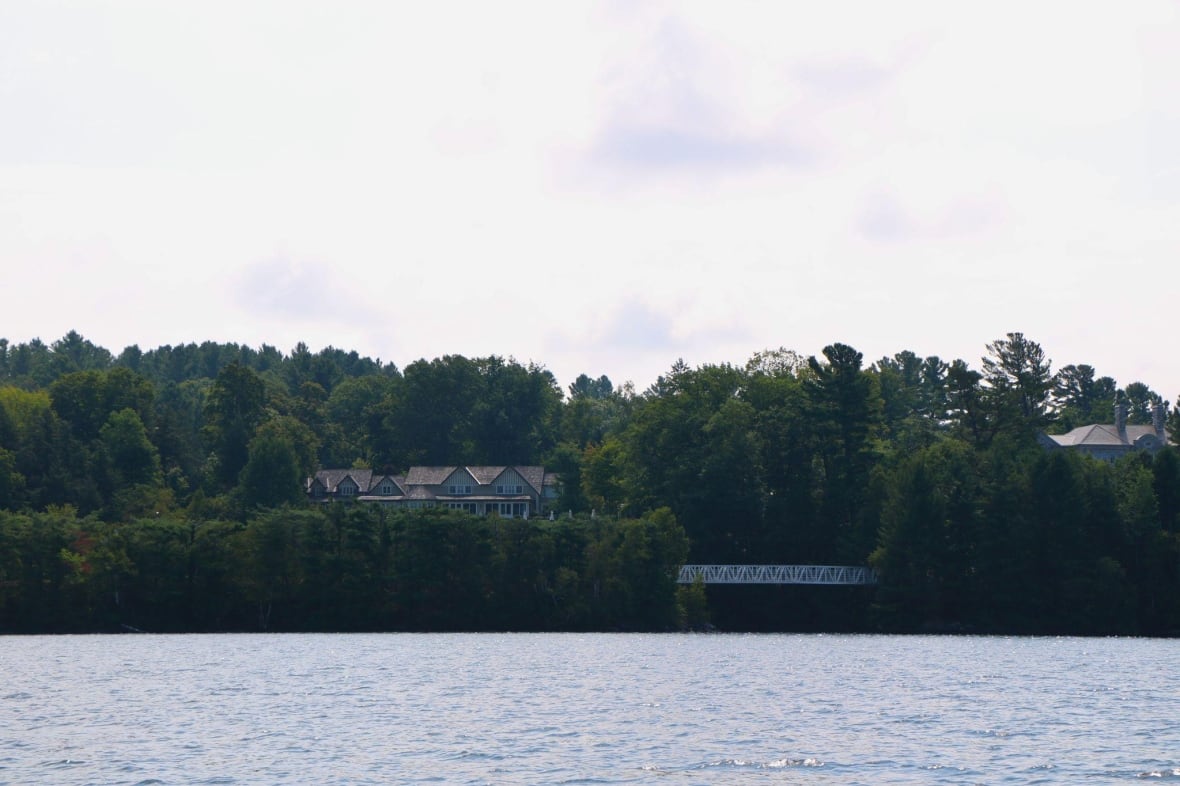 The view of a lakefront house from the water. 