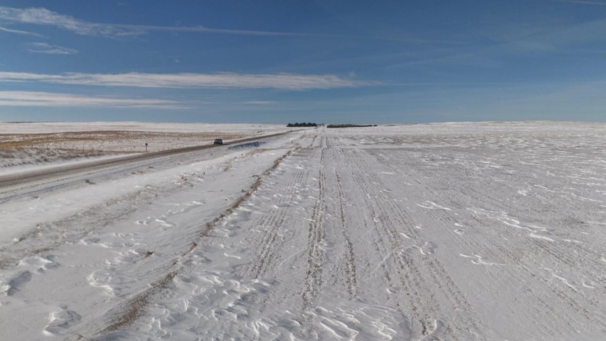 A shot of a field covered in snow is pictured.