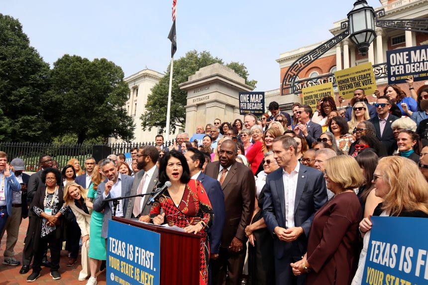 Texas State Sen. Carol Alvarado, a Democrat, speaks in a crowd of other Democratic state lawmakers outside the Massachusetts State House on August 6 in Boston.