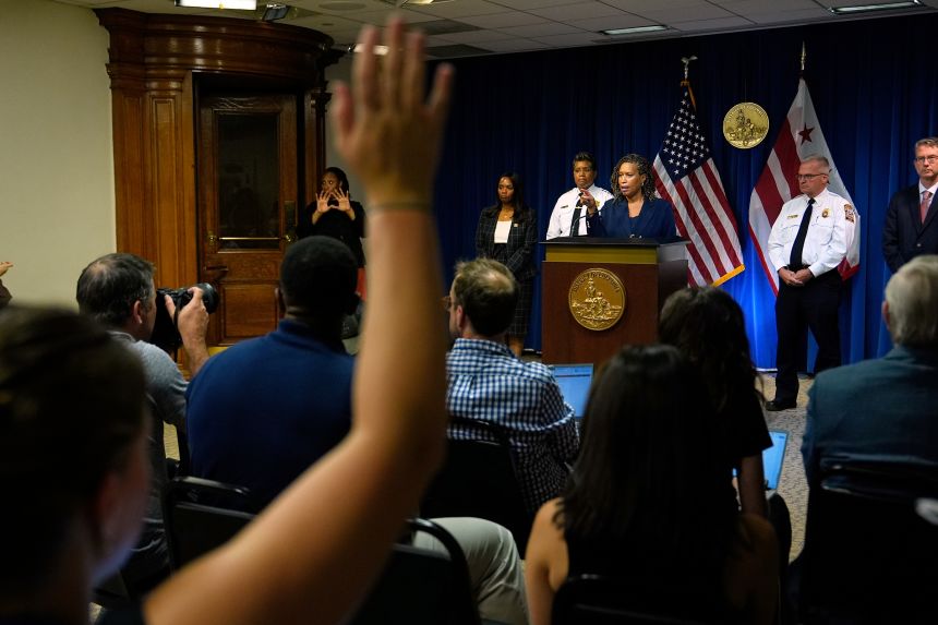 District of Columbia Mayor Muriel Bowser speaks as Metropolitan Police Department Chief Pamela Smith, on stage third left, and DC Fire and EMS Chief John Donnelly, on stage second right, listen during a news conference  on August 11 in Washington, DC.