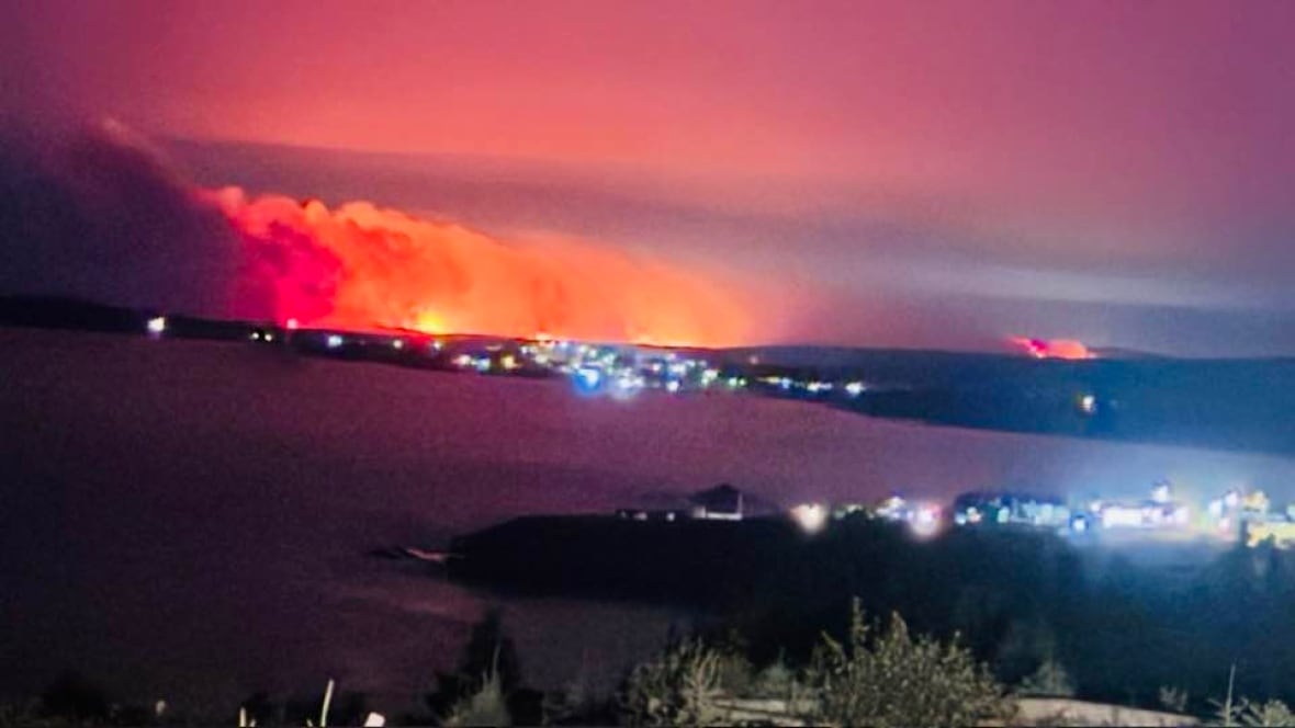 Fire burning near town in distance
