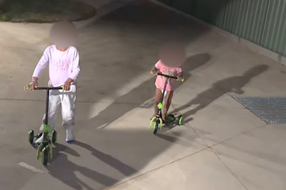 The children playing on scooters outside the unit before emergency services arrived on scene. 