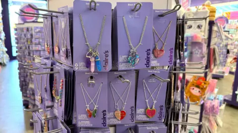 Getty Images Lots of necklaces on sale on a Claire's shopping rack