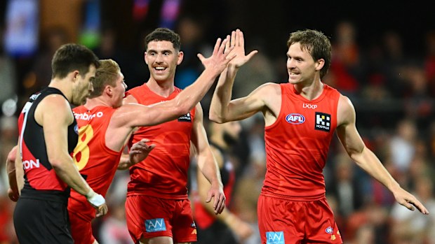 Noah Anderson of the Suns celebrates kicking a goal.