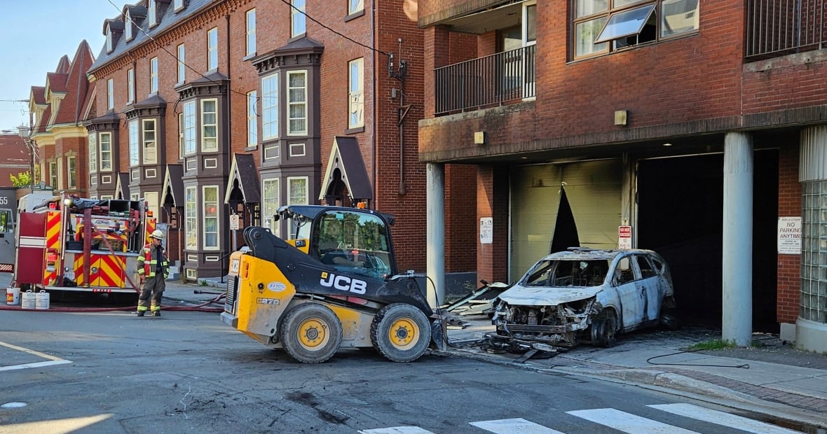 firefighters and a burned car