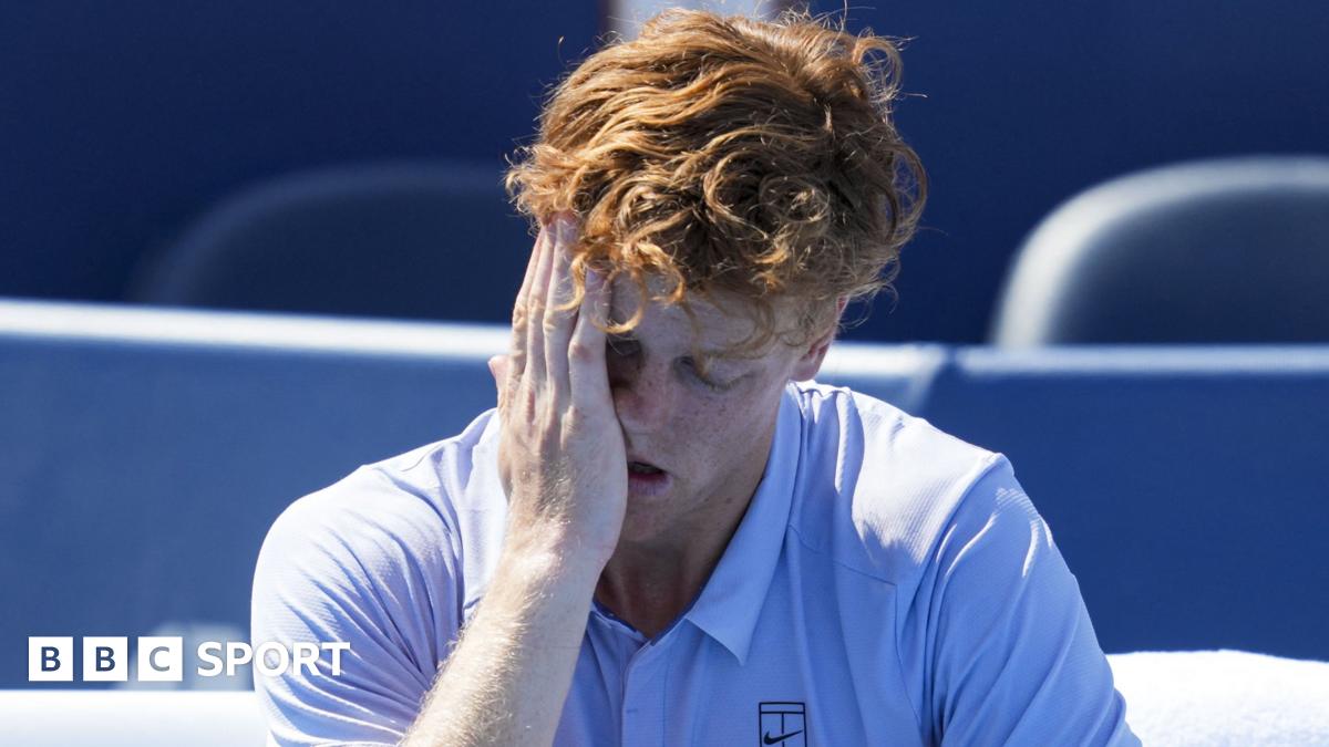 Jannik Sinner holds his head in his hand after retiring with illness from the Cincinnati Open final against Carlos Alcaraz