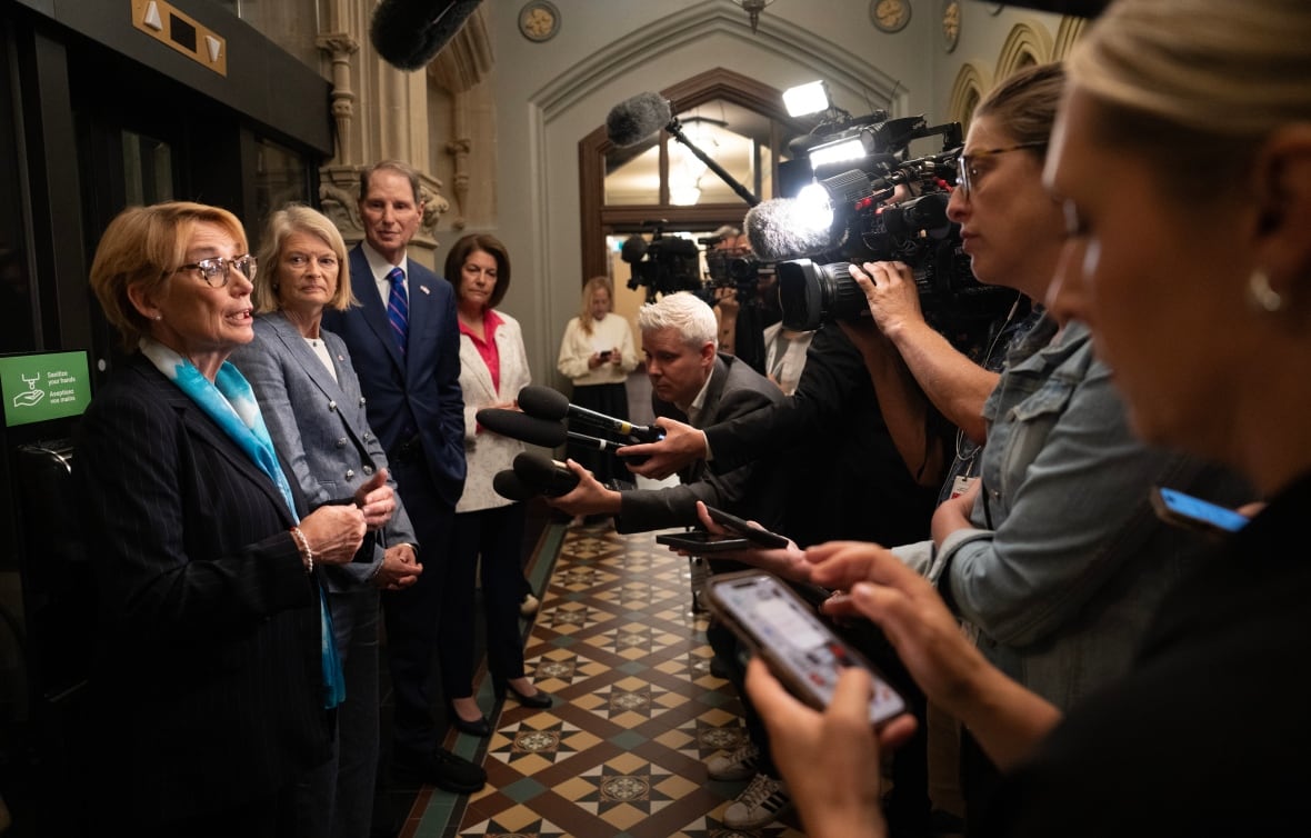 US Senator Lisa Murkowski, second from left, Senator Ron Wyden and Senator Catherine Cortez Masto listen to Senator Maggie Hassan, left, as she speaks with media following a meeting with the prime minister on Parliament Hill in Ottawa, on Monday, July 21, 2025.