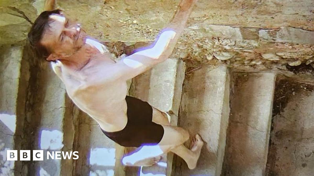 Paul Brown is white with short brown hair and has a moustache