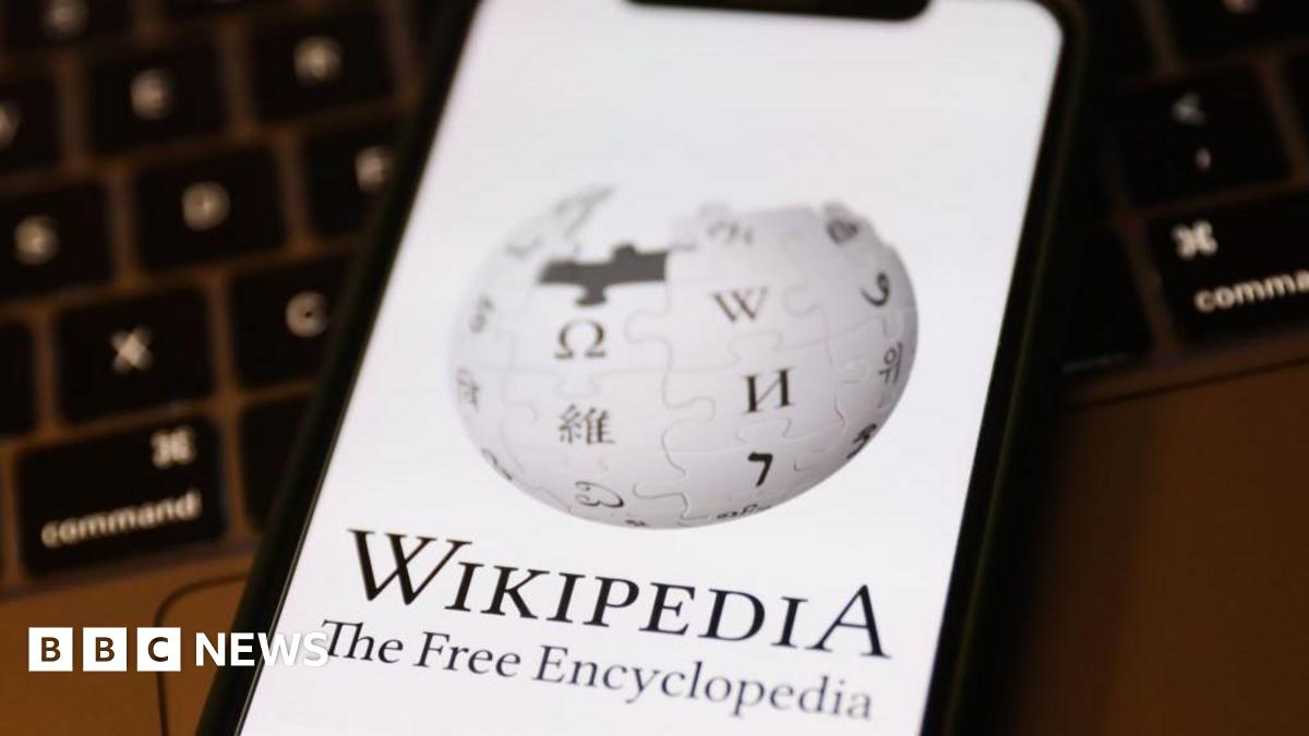 Wikipedia logo on a phone screen. The logo is a globe made out of puzzle pieces. On each puzzle piece is a letter of the alphabet taken from a different language's alphabet - for example, there are Greek, Arabic and Cyrillic characters visible as well as Kanji.