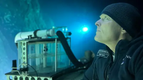 David Lochridge David Lochridge in a submersible looking out at an underwater reef 