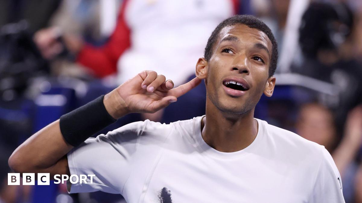 Felix Auger-Aliassime cups his ear at the US Open