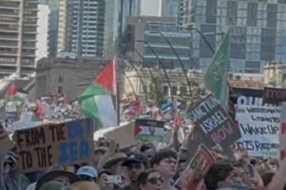 A photograph of the Brisbane rally shows what appears to be the Hamas flag in green and white.