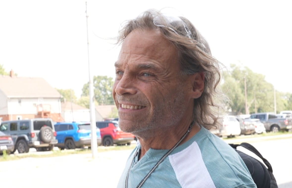 Close-up of Dave smiling on a sunny day. 