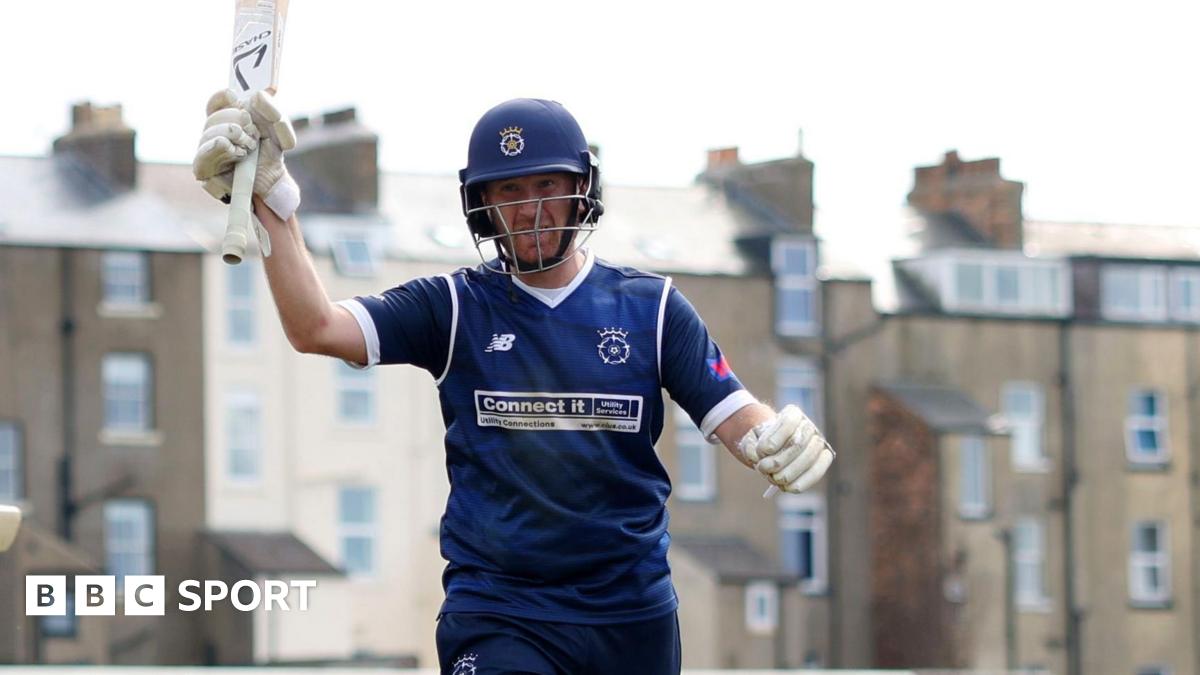 Liam Dawson raises his bat to acknowledge applause from the crowd at the end of his innings against Yorkshire in Scarborough