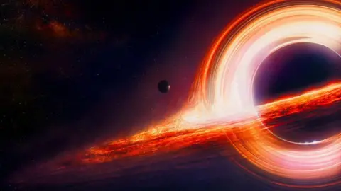 All About Space A classic illustration of a black hole in space. The event horizon is a bright orange spiral and it is black in the space beyond. A small moon can be seen approaching the event horizon.