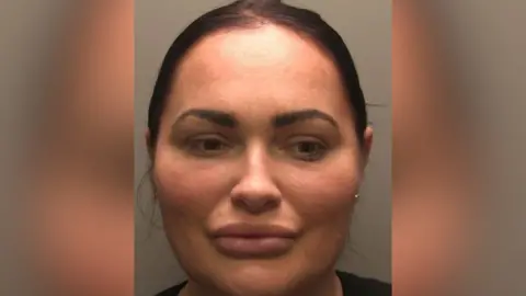 Lincolnshire Police Police custody picture of Natasha Allarakhia. She has black hair tied back. 