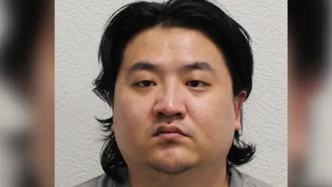 Metropolitan Police Chao Xu, a man with floppy dark hair, looks straight ahead into the camera.