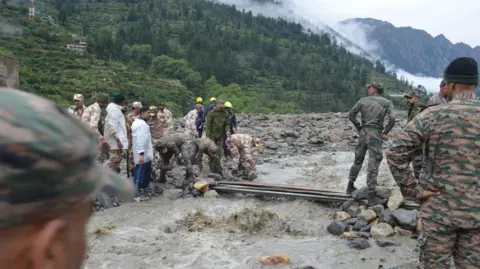 A damaged road in Dharali after flash floods in the region.