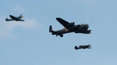 PA Media Flypast by World War Two-era aircraft the Spitfire, Hurricane and Lancaster bomber