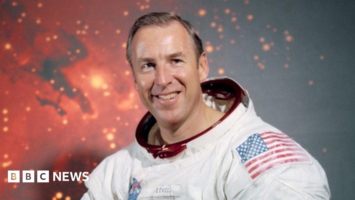 James Lovell is photographed wearing his astronaut suit albeit without his helmet.