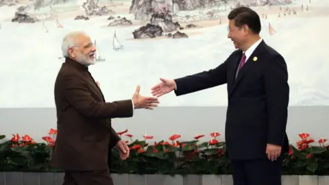 Getty Images Indian Prime Minister Narendra Modi (L) shakes hands with Chinese President Xi Jinping (R) prior to the dinner on September 4, 2017