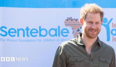 Prince Harry with a banner of the Sentebale charity in 2019