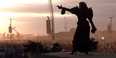 Chappell Roan is silhouetted on stage at the Reading Festival