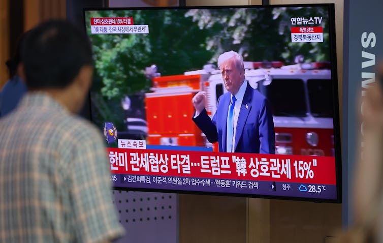 A television screen inside Seoul Station broadcasts a news report