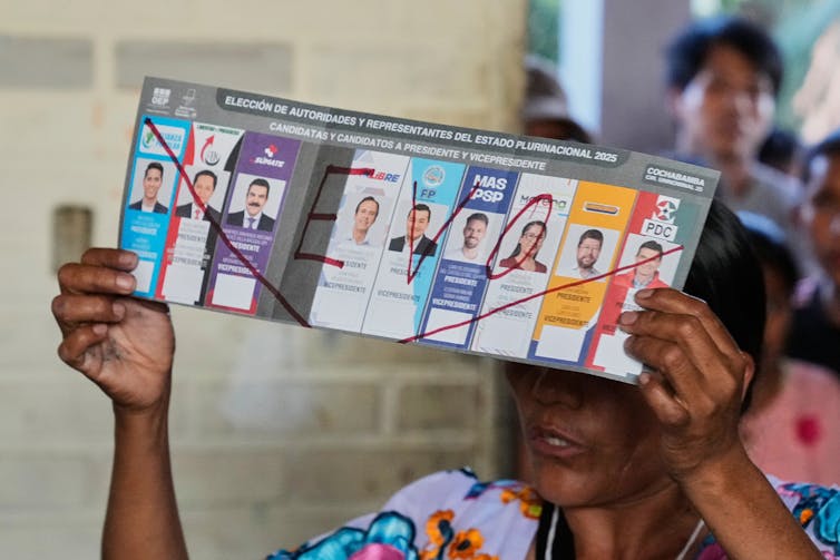 A person holds up a candidate list.