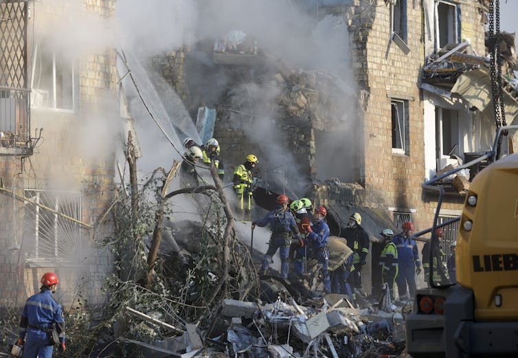Ukrainian rescue workers at the site of a Russian strike on a residential building in Kyiv.