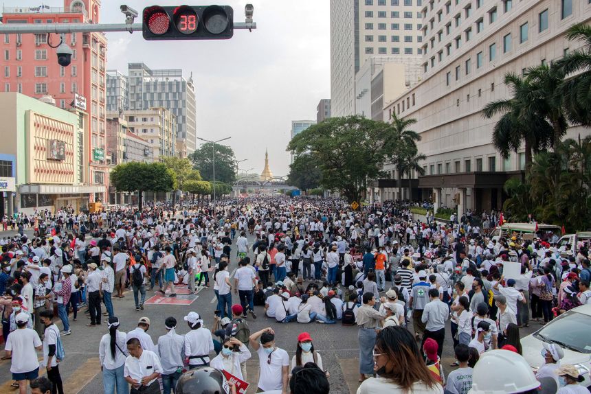 Protesters sit in the middle of the street during the demonstration to protest against the military coup on February 1, 2021 in Yangon, Myanmar.