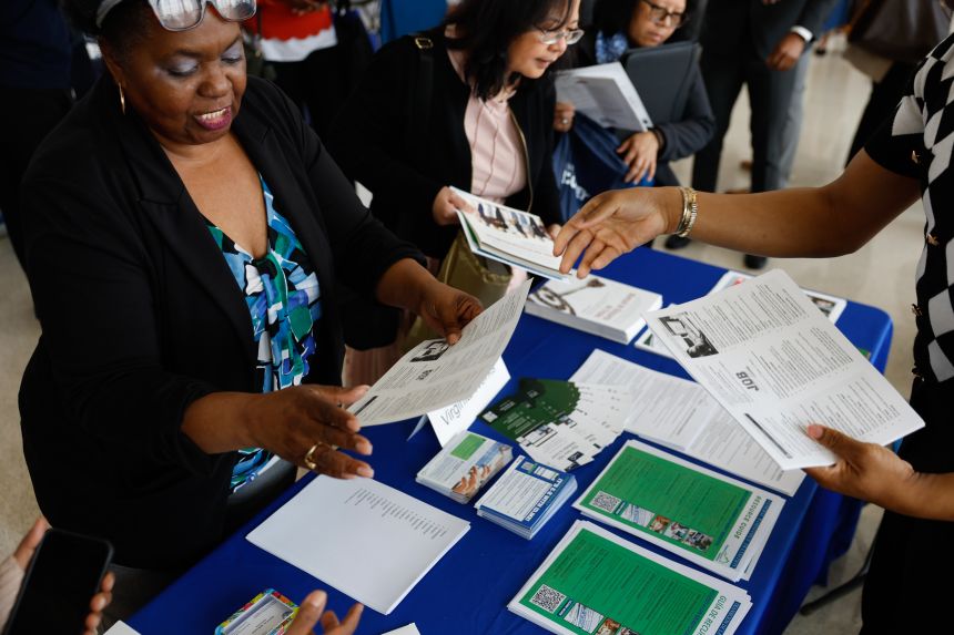 Hiring representatives speak with jobseekers.