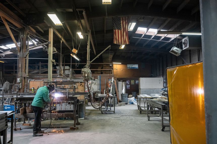 A worker arc welds a metal door during production at the Metal Manufacturing Co. facility in Sacramento, California, US, on Tuesday, May 27, 2025.