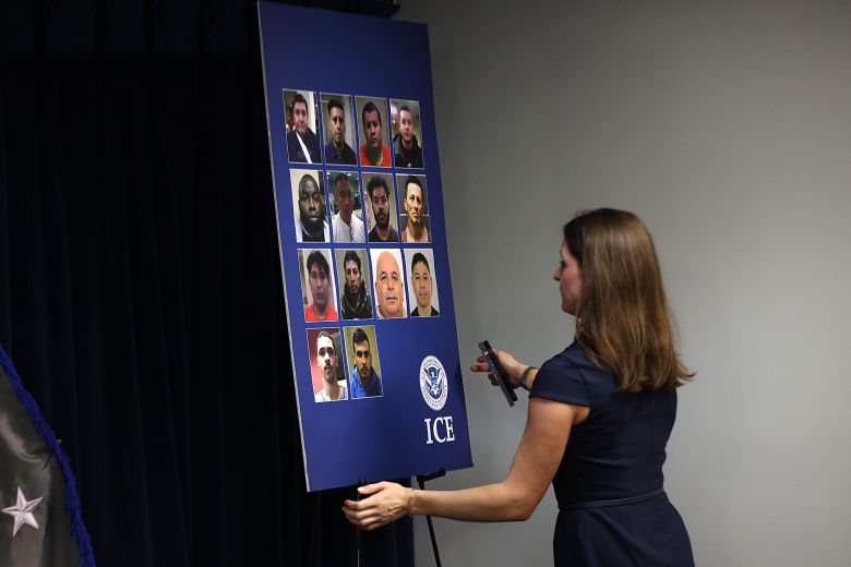 Photos of detained immigrants are shown at an ICE news conference on June 2.