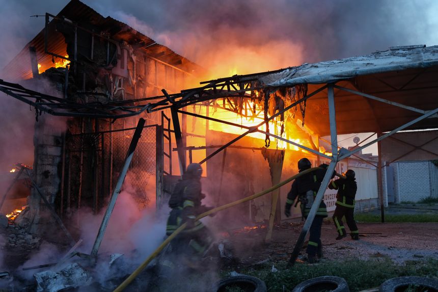 Rescue workers extinguish a fire on a civilian enterprise in the Novobavarskyi district struck by a Russian drone on June 4, 2025, in Kharkiv, Ukraine.