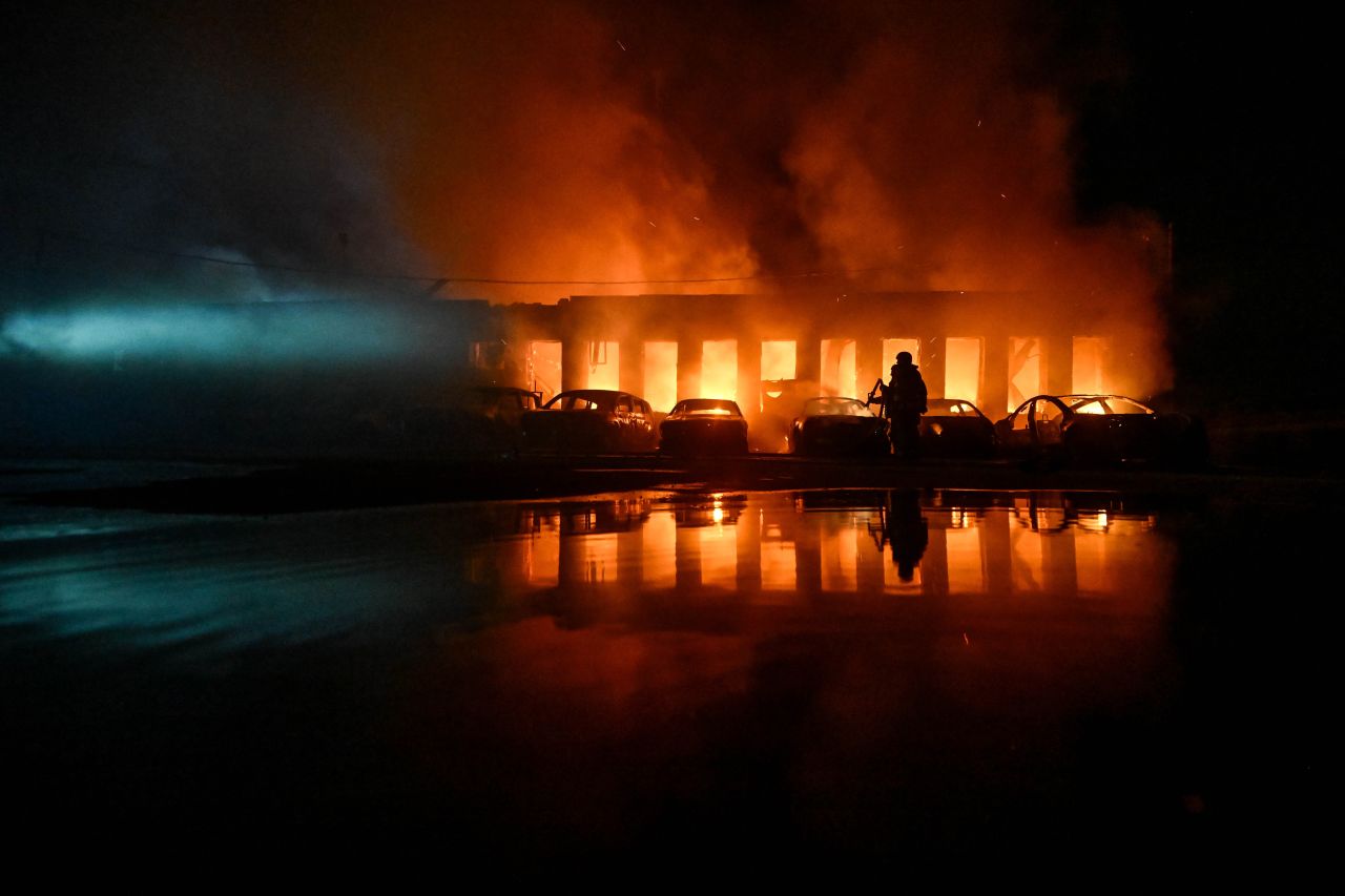 A rescuer pours water onto burning cars during a response effort to a Russian drone attack in Zaporizhzhia, Ukraine, on June 18.
