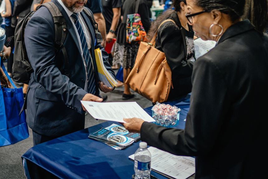Recruiters and job seekers speak during a job fair hosted by the Cook County government to support federal workers in Chicago, Illinois, on Thursday, June 26, 2025.
