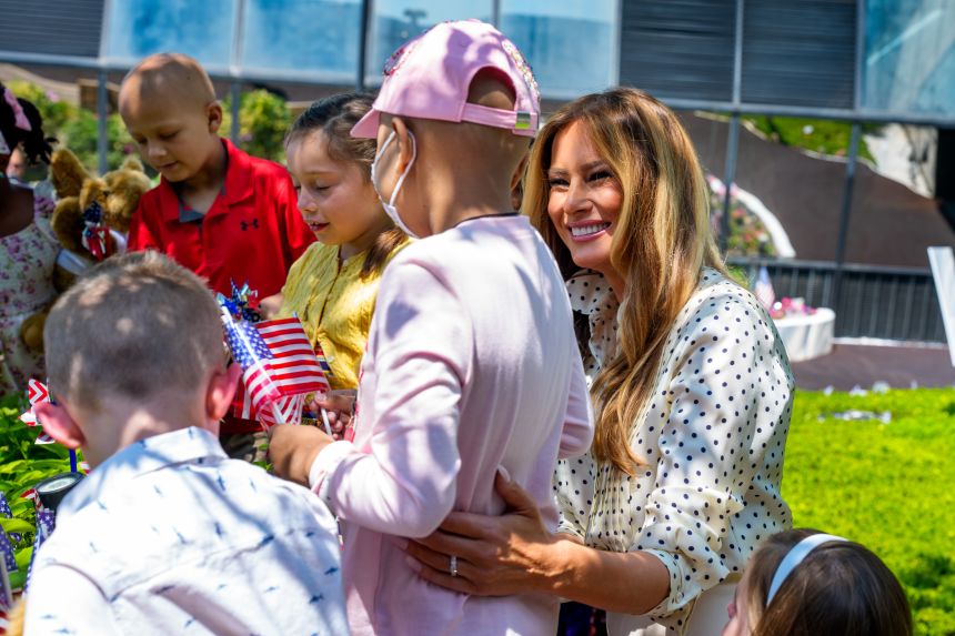 First lady Melania Trump helps children add July 4th decorations to the Bunny Mellon Healing Garden at Children's National Hospital on July 3 in Washington, DC.
