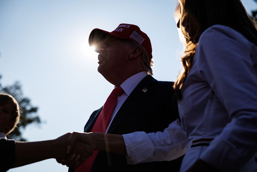 President Donald Trump and first lady Melania Trump greet guests during an Independence Day military family picnic at the White House on July 4.