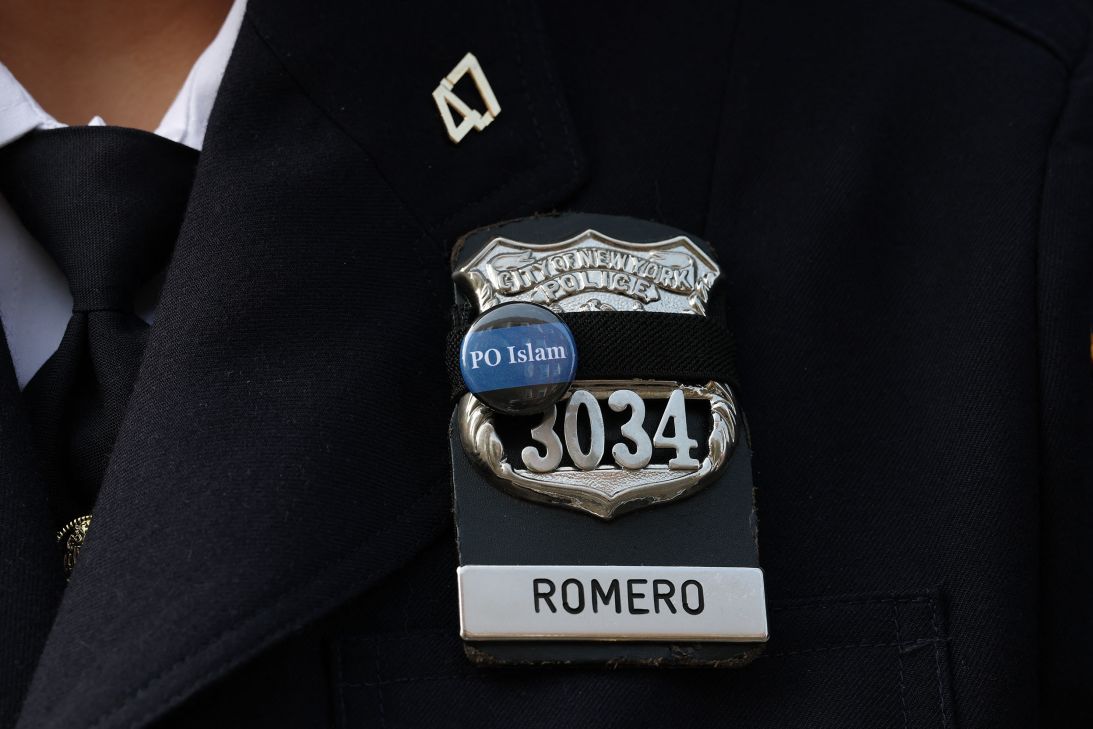 An NYPD officer wears a pin in honor of Officer Didarul Islam, who joined the department as a school safety agent in 2019 before becoming a police officer.