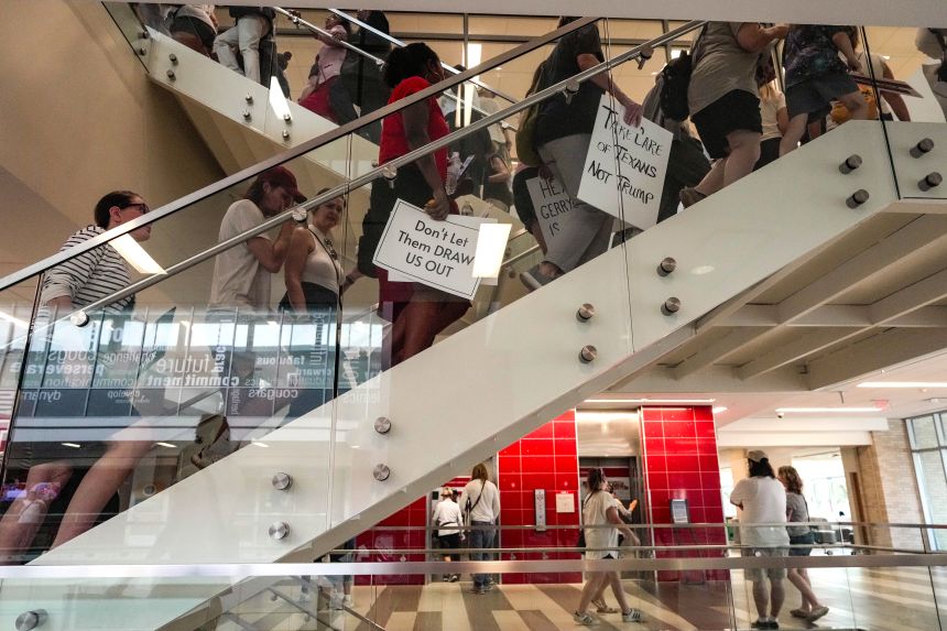 People and elected officials gather for a public hearing on the proposed congressional redistricting on Saturday, July 26, 2025 in Houston.