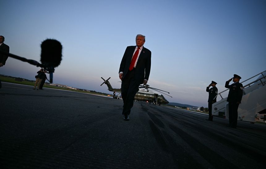 US President Donald Trump walks to speak to the media at Lehigh Valley International Airport in Allentown, Pennsylvania, on August 3, 2025 as returns to the White House from his Bedminster residence, where he spent the weekend.