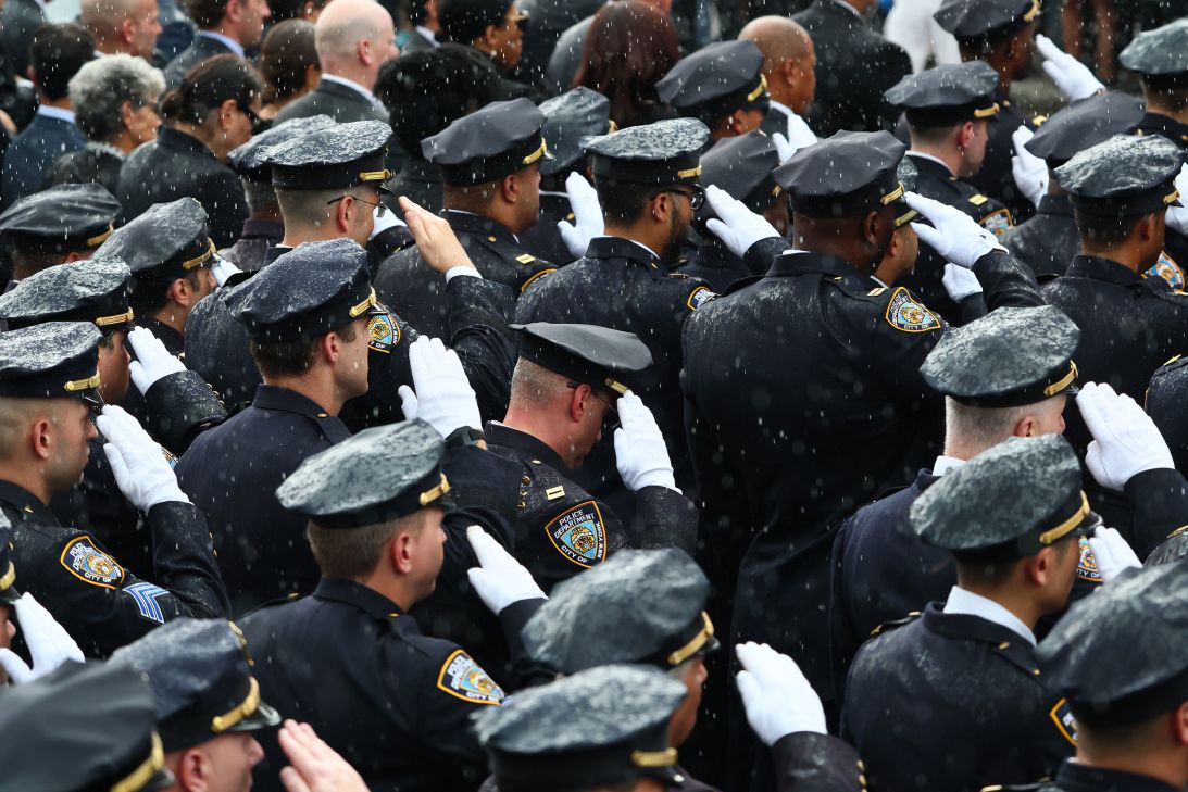 Members of the NYPD and other law enforcement agencies lined the streets during the funeral procession, offering a salute for the slain officer.