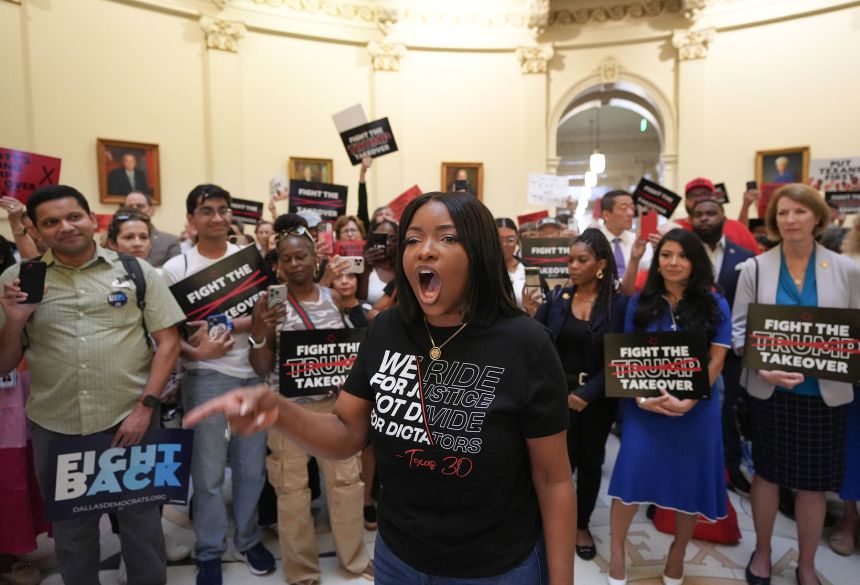 Rep. Jasmine Crockett protests redistricting plans before the hearing of the House Select Committee on Congressional Redistricting at the Capitol in Austin, on August 1.